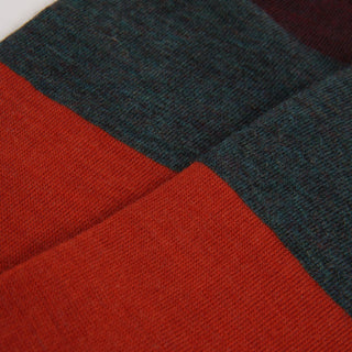 Close-up of orange and dark green fabric with a textured pattern