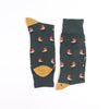 A pair of men's socks with a Christmas-themed design featuring a robin