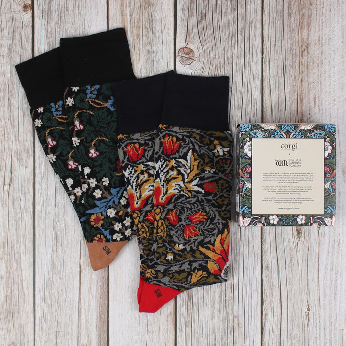 2 pairs of William Morris socks on a wooden background with gift box
