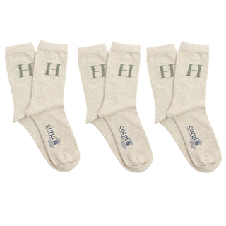 Set of beige socks with 'H' letter on a white background