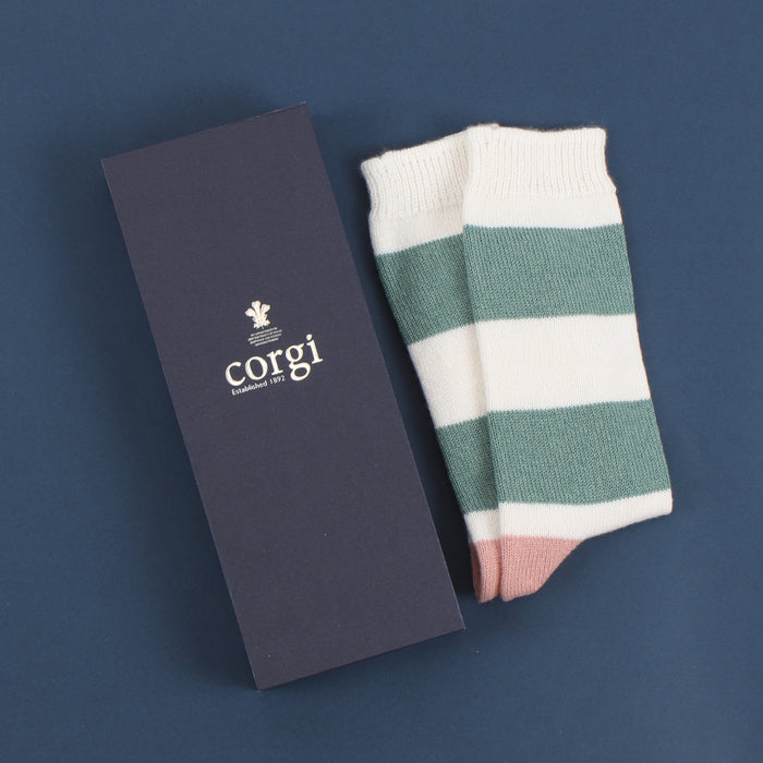 A pair of women's cashmere and cotton colour block socks with stripes in green and pink shades, and a gold toe with gift box.