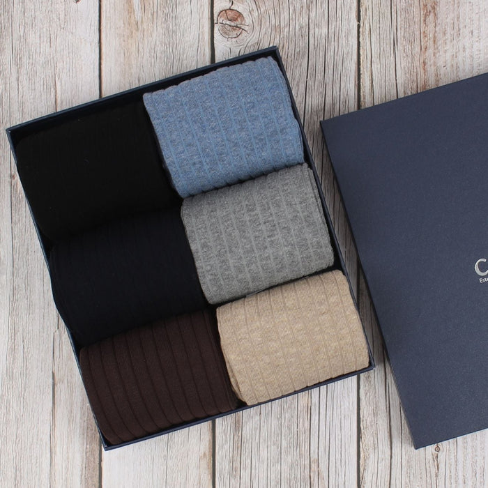 A set of men's socks displayed in a box, with a variety of colors including black, blue, brown, and beige.