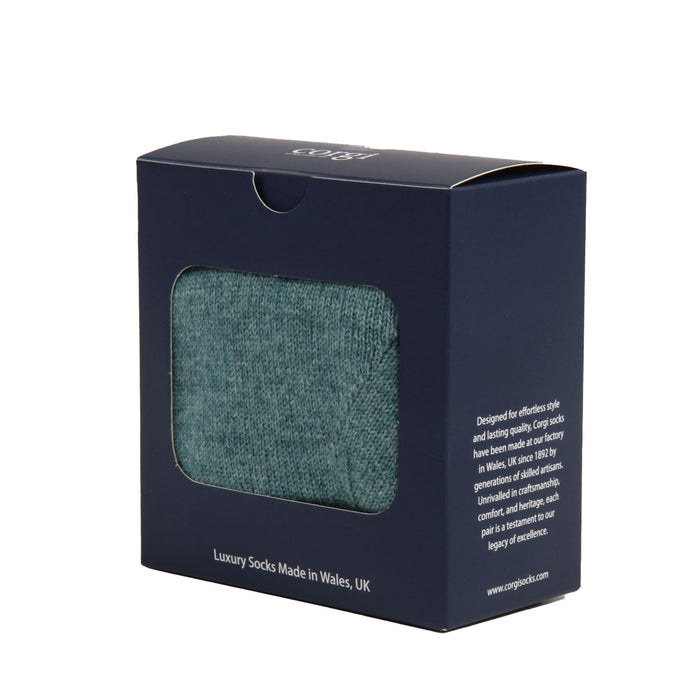Navy blue packaging box with a window displaying green socks, featuring Corgi Socks branding.