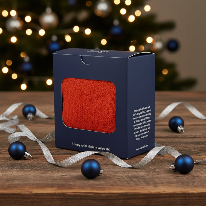 Box of orange gloves with a visible brand name on a white background