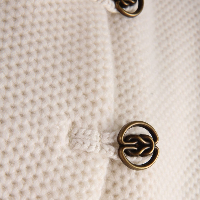 Close-up of a textured fabric with a decorative metal button
