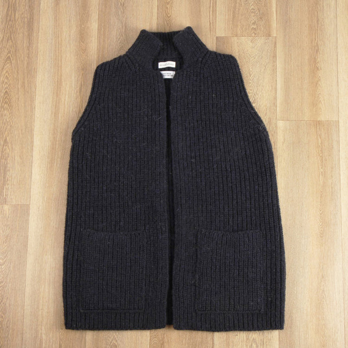 Dark grey ribbed knit vest on a wooden floor