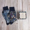 2 pairs of William Morris socks with a gift box on a wooden background