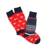 Two pairs of socks with different patterns , one pair with corgi dogs the other a traditional fairisle design photographed on a white background