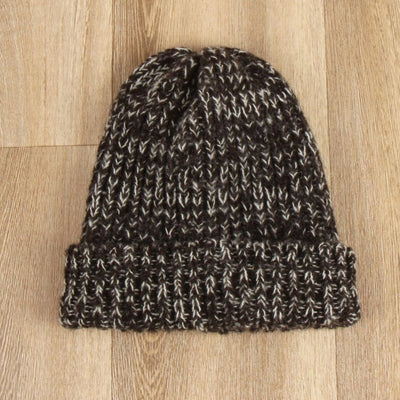 Knitted beanie on a wooden surface