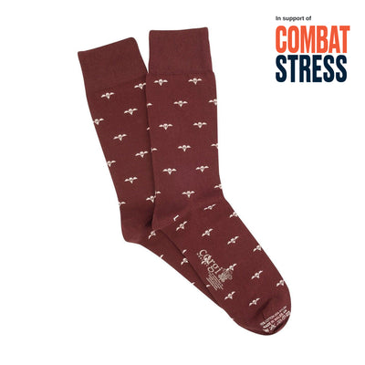 Maroon socks with white patterns on a white background, featuring 'Combat Stress' text.