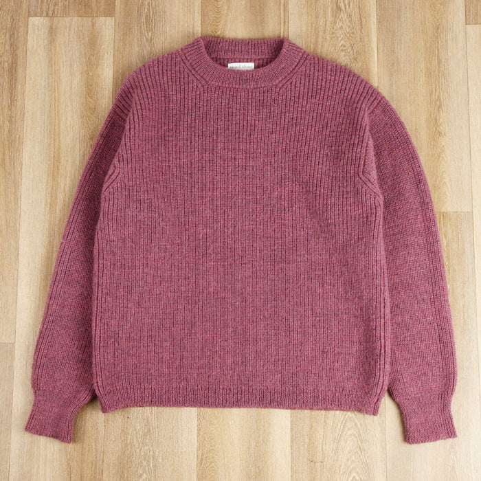 dusty pink crew pullover on a wooden surface