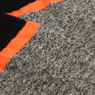 Close-up of gray fabric with orange and black stripes