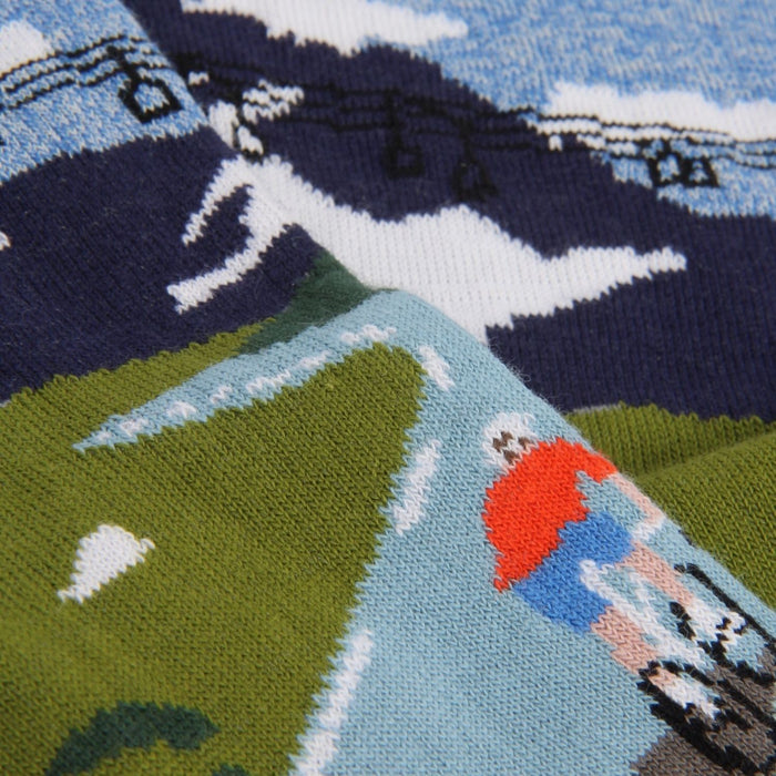 Close-up of a sock with a cyclist peddling up a mountain.