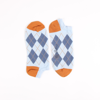 Pair of socks with blue diamond pattern and orange accents on a white background