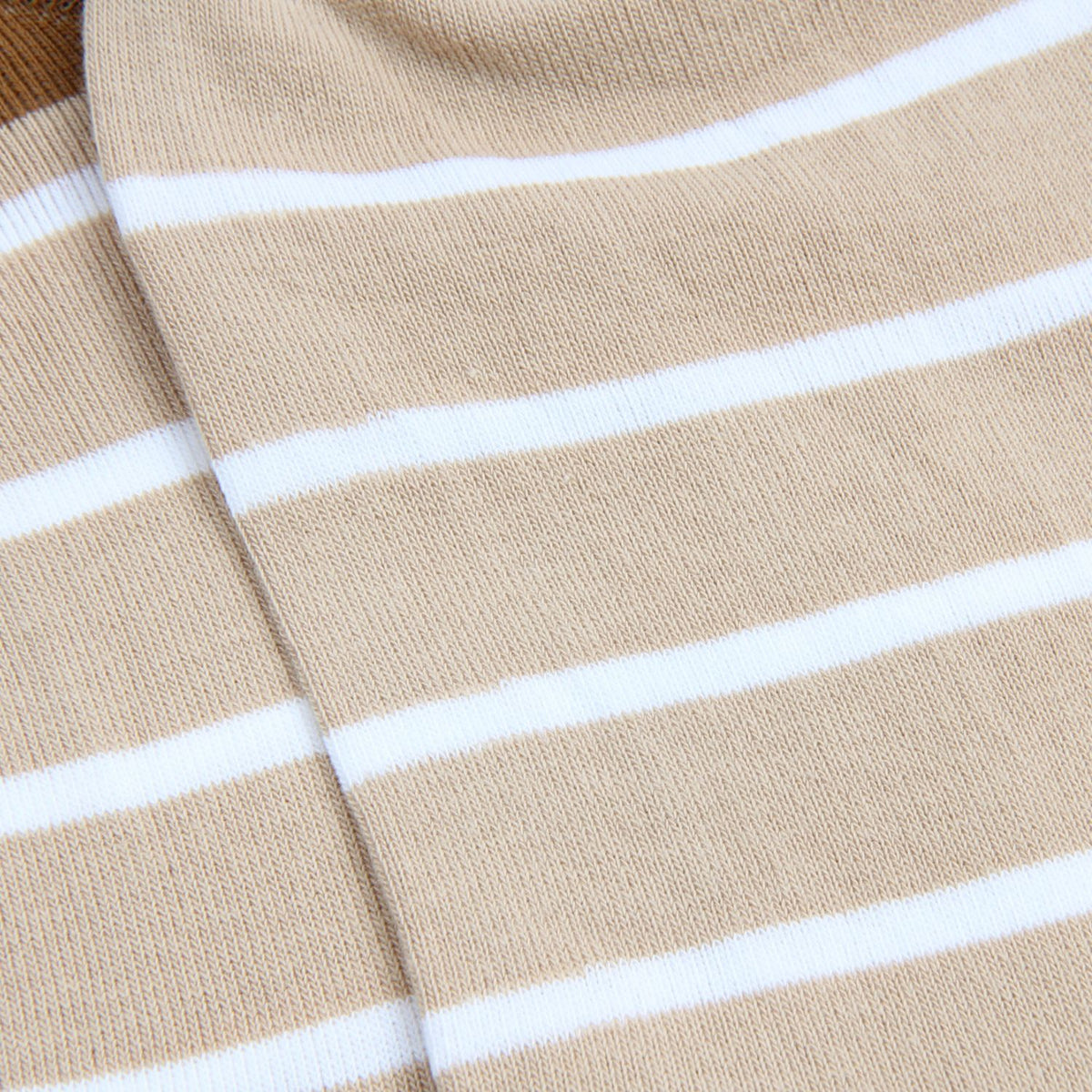 Close-up of beige fabric with white stripes