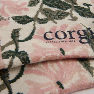 Floral patterned fabric with 'corgi' branding on a white background