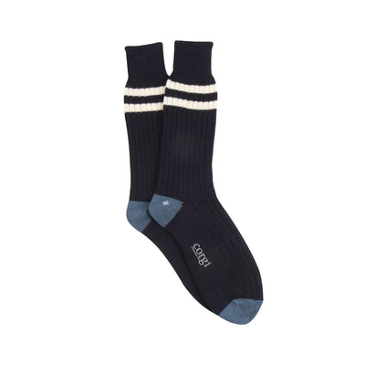 navy socks with white stripes and blue toes and heel photographed on a white background