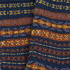 Close-up of a knitted fabric with a pattern of blue, orange, and yellow stripes.