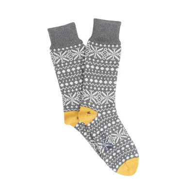 Gray socks with snowflake pattern and yellow accents on a white background