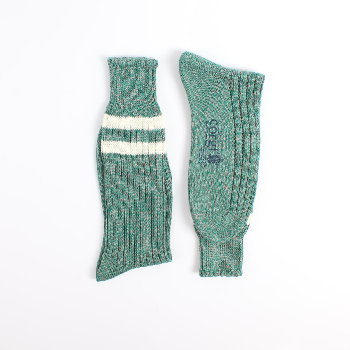 Pair of green socks with a white stripe photographed on a white background