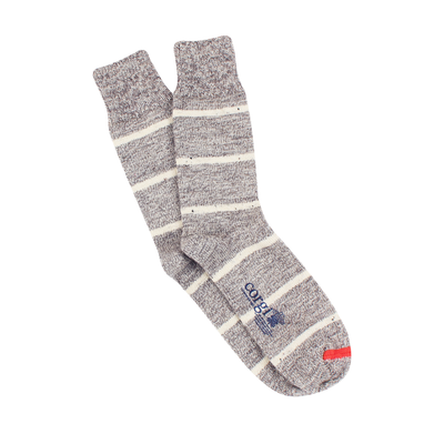 A pair of men's striped socks made from British wool, primarily in gray color with white stripes, showing the heel and toe areas.