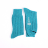 Pair of teal socks with a logo on a white background