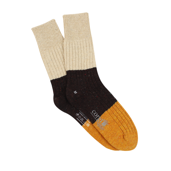A pair of men's color block donegal wool socks with a black, beige, and yellow design, mid-calf length, with a ribbed cuff.