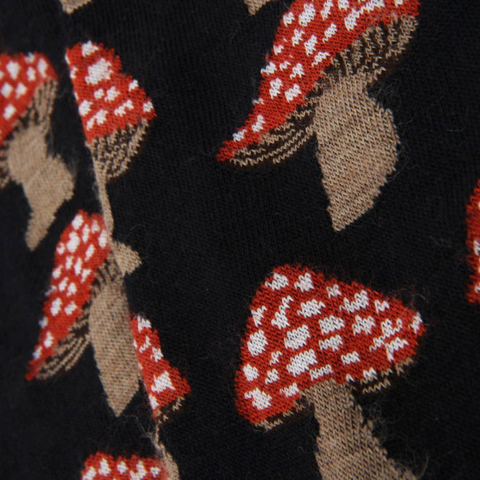 Close-up of fabric with red and white patterned shapes on a Navy background