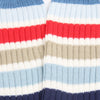 Close-up of striped fabric with red, white, blue, and beige colors.