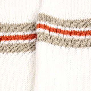 Close-up of a sock with horizontal stripes in beige, orange, and white on a white background