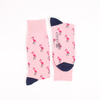 Pink socks with flamingo pattern and navy toes on a white background