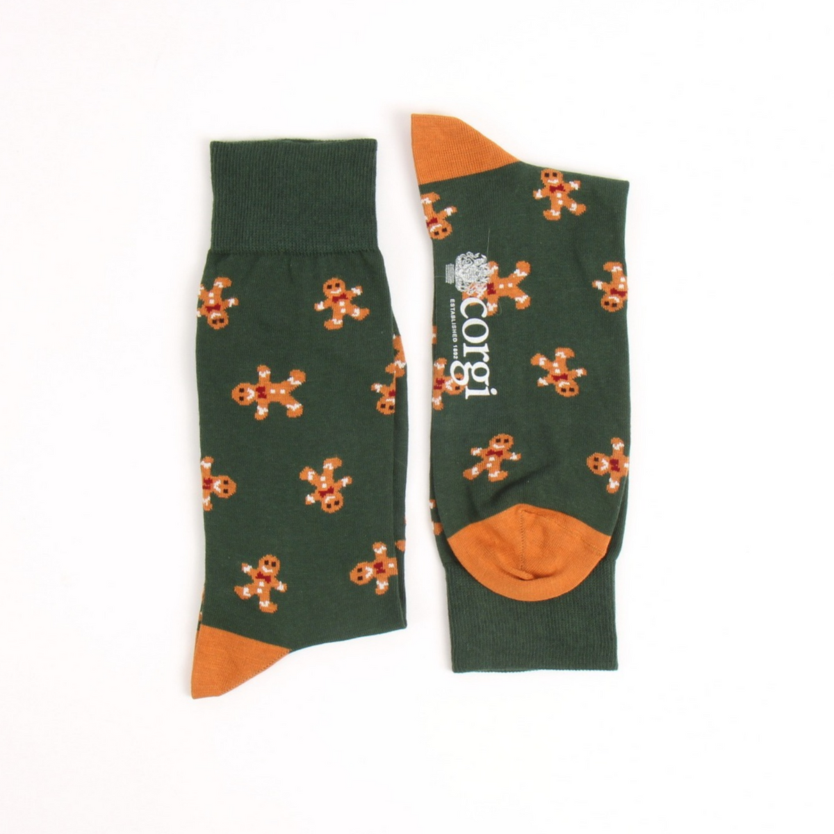 A pair of dark green crew socks with an all-over gingerbread man pattern and contrasting orange heels, toes, and cuffs, displayed flat on a white background.