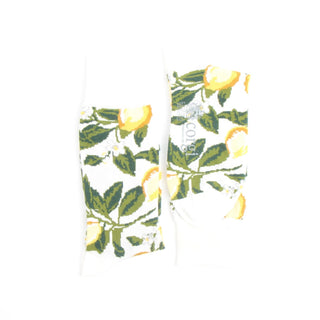 Socks with lemon and leaf pattern on a white background