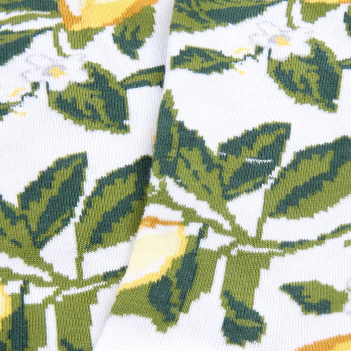 Close-up of a fabric with green leaf pattern on a white background