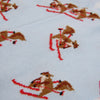 Cross-stitched pattern of a squirrel on skis on a pale blue fabric
