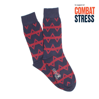 Navy blue socks with red geometric pattern on a white background, featuring 'Combat Stress' text.