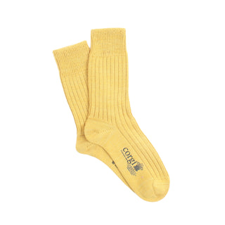 Pair of yellow socks with a brand logo on a white background