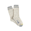 A pair of beige and gray striped cuff British wool socks with a yellow detail at the toe.
