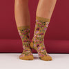 Floral patterned socks worn by a person against a red background