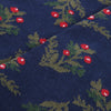 Navy fabric with green leaf and red berry pattern