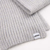 Grey knit beanie with a brand label on a white background