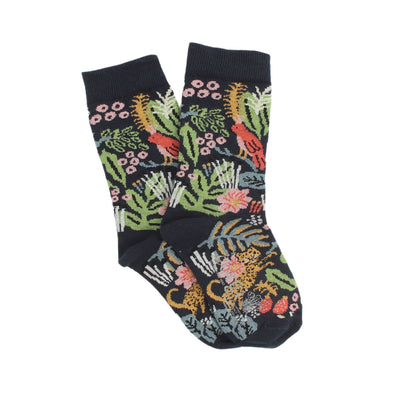 A pair of children's cotton socks with a jungle-themed pattern including colourful plants, flowers, and animals like leopards and birds on a navy background.