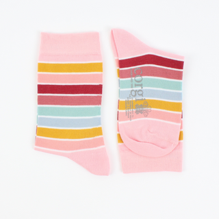 A pair of striped cotton socks on a child's feet, featuring multiple colours including blue, orange, and pink.