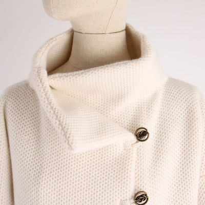 Close-up of a textured jacket on a mannequin with a plain background
