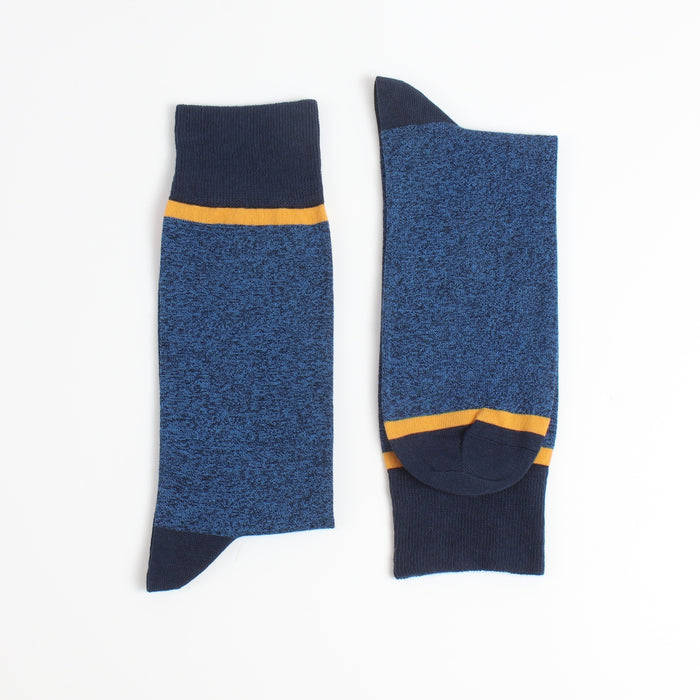 Pair of blue socks with yellow accents on a white background