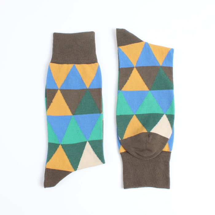 Colourful geometric-patterned socks photographed on a white background