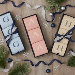Women's Letter Socks in gift boxes on a festive flat lay table.