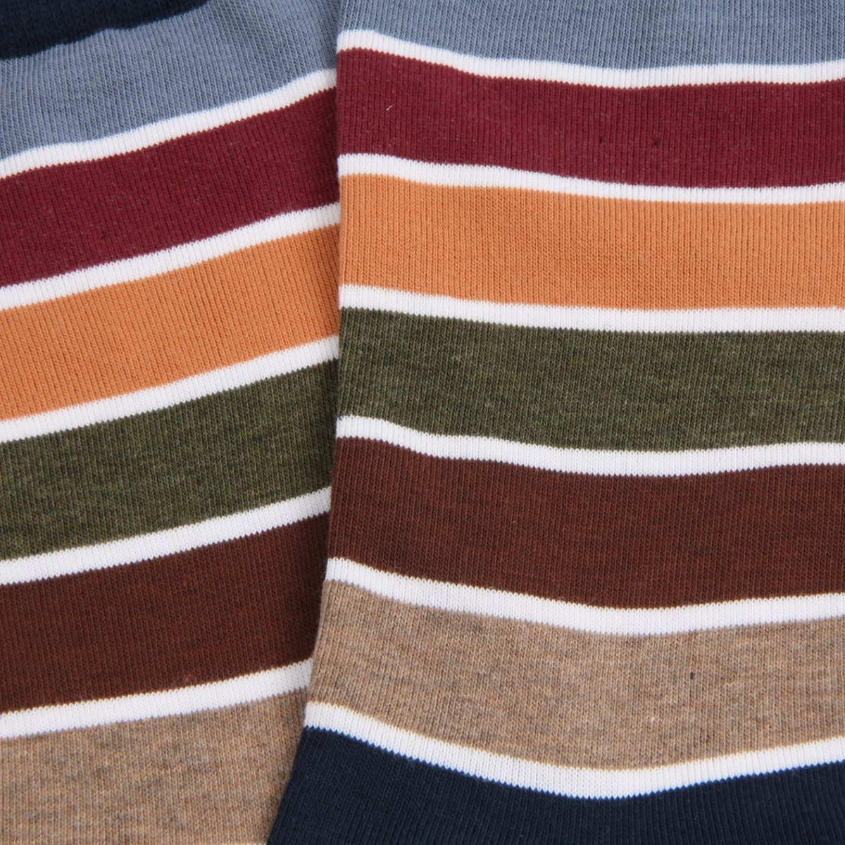 Close-up of a striped knit fabric with horizontal bands of navy, white, brown, burgundy, orange, olive green, and beige.