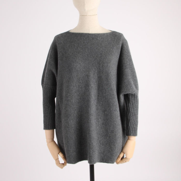 Gray sweater on a mannequin against a white background