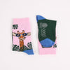 Colourful socks with a giraffe design on a pink background
